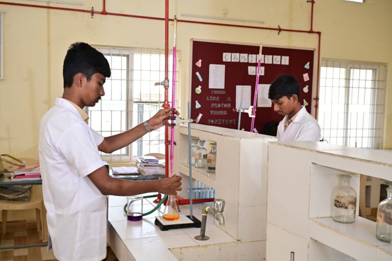 Students conducting experiments in the chemistry lab at Sir C.R. Reddy School